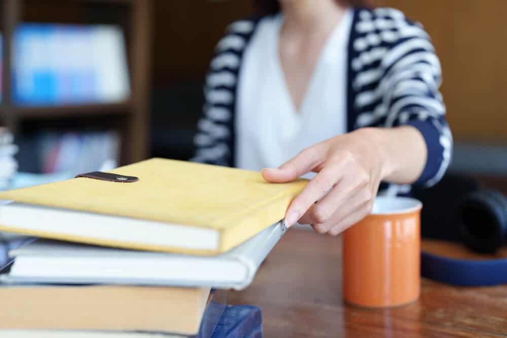 stack of personal finance books on table