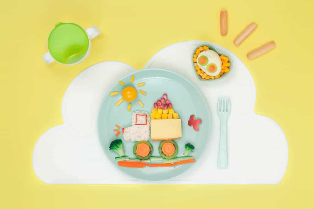 A balanced meal plate for toddlers, with fruits and veggies in a shape of a truck.