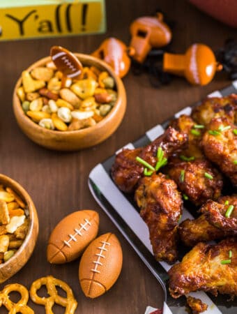 game day food ideas with a spread of appetizers like, buffalo wings, pretzels, and nuts.