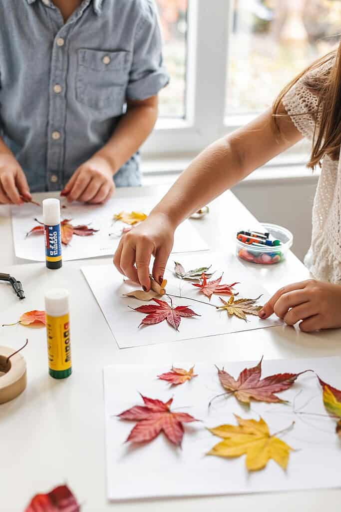 Colorful autumn leaves crafting with kids for fall seasonal activities.