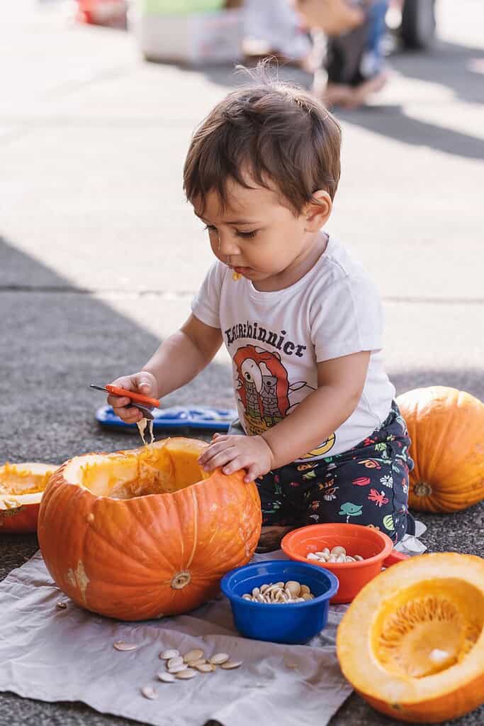 Pumpkin carving toddler outdoor fall activity for children.