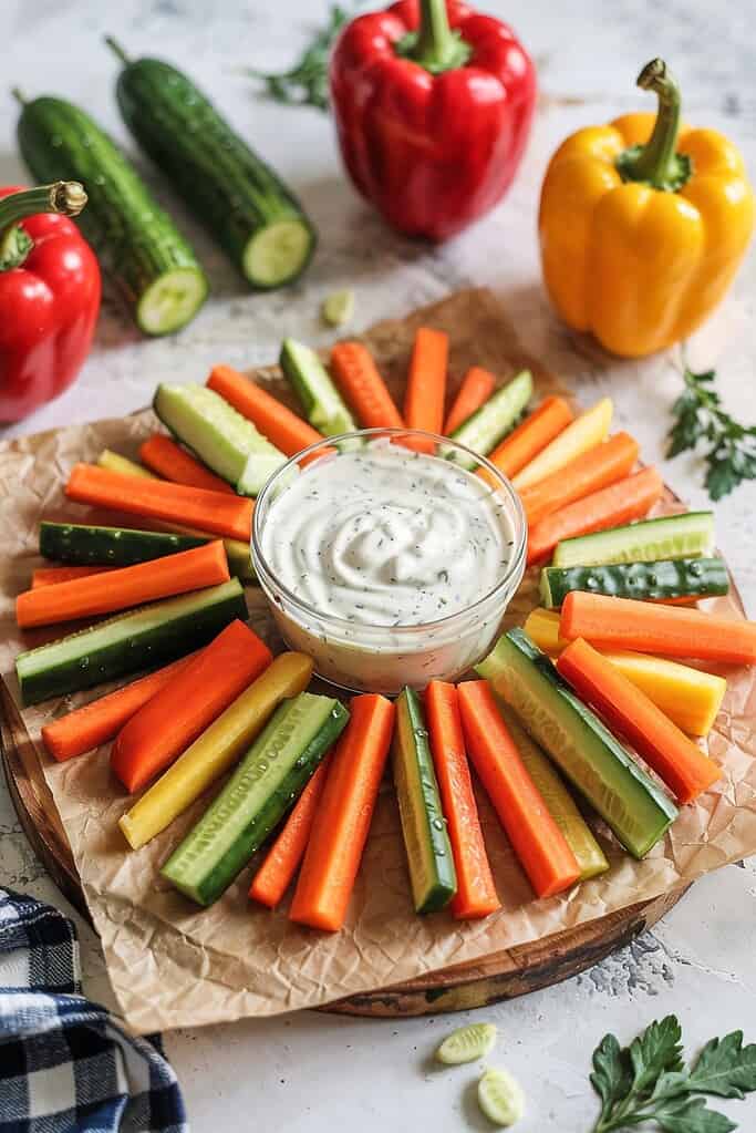 Fresh vegetable platter with creamy dip for healthy snacks.