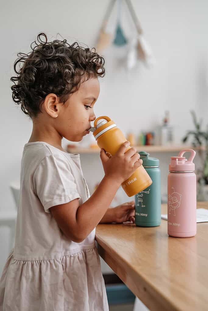a child drinking from a bottle